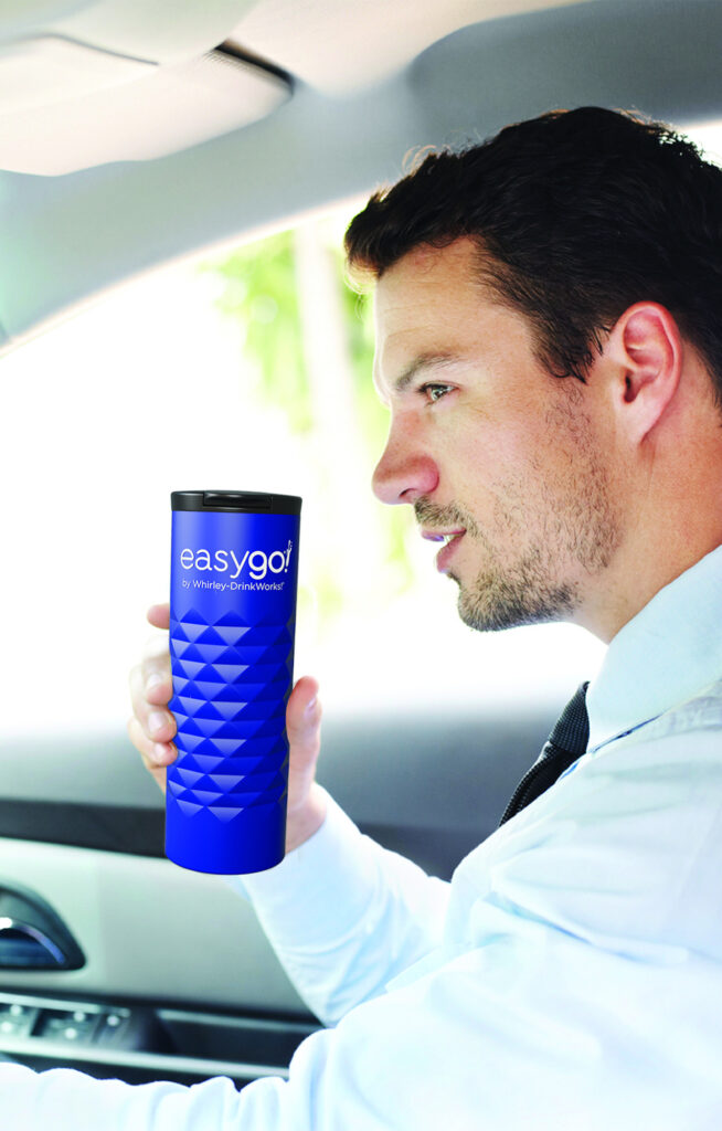 Man holding a premium stainless-steel cup while driving.