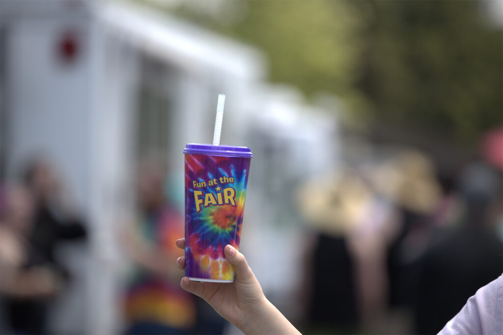 Promotional cup held by a festival attendee.